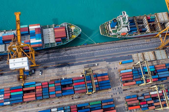 Cargo terminal with ships and containers from above.