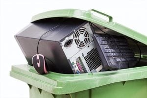 Electronics collected for recycling in a bin.