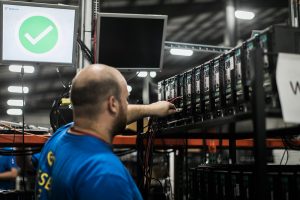 Electronics recycling employee working at CSI facility.