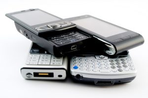 A stack of old mobile phones for recycling.