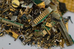Shredded e-scrap showing gold and other metals.