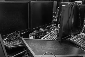 Computer monitors and keyboards gathered for recycling.