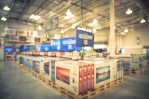 Tvs on display for sale at a warehouse store.