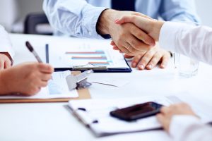 People shaking hands at a business meeting.