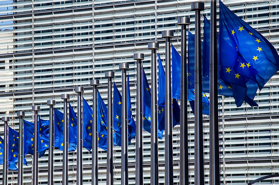 E.U. flags in front of the European Commission building.