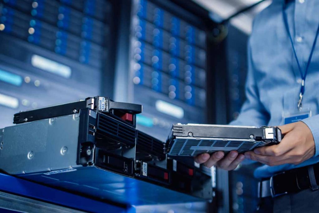 Data center technician replacing a drive.