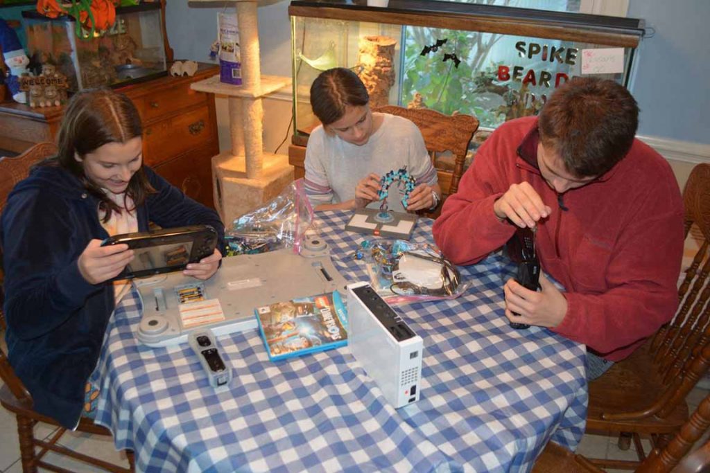 Family repairing devices before donating.Samsung