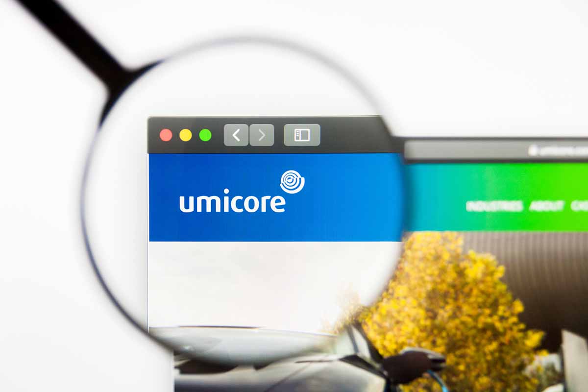 Umicore logo on a screen under a magnifying glass.