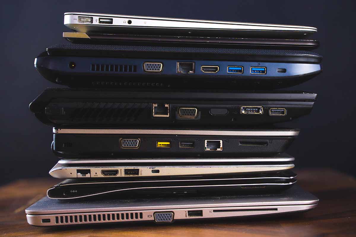 Laptops stacked for recycling.