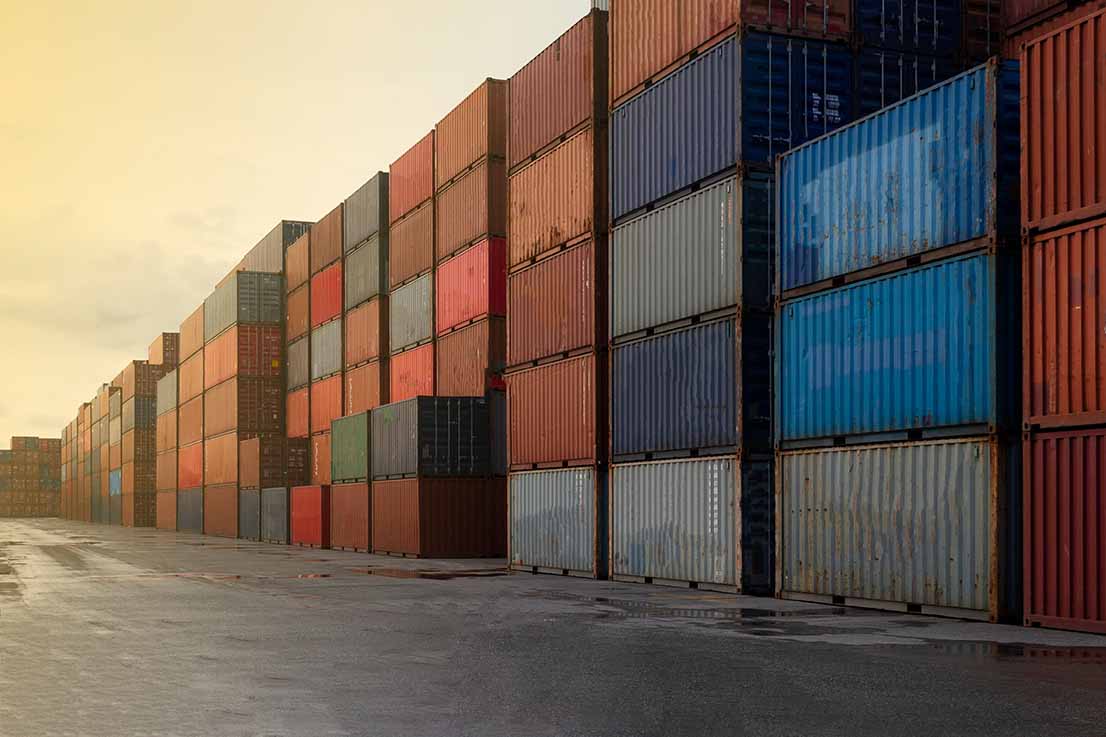Shipping containers stacked at a logistic hub.