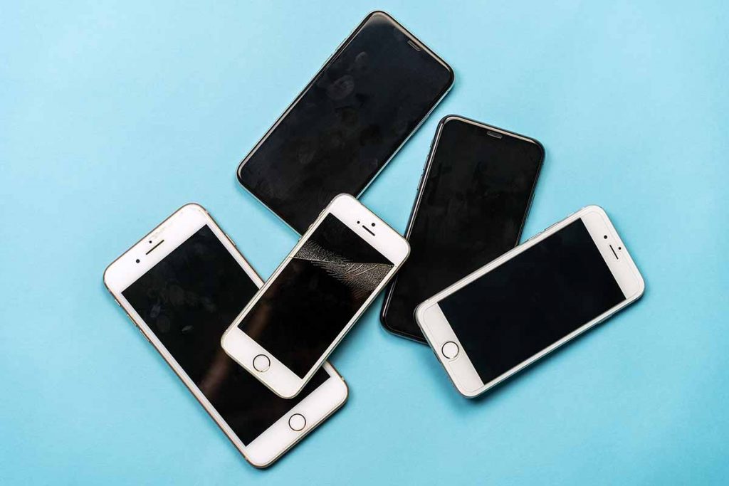 Used mobile phones located on a blue background.