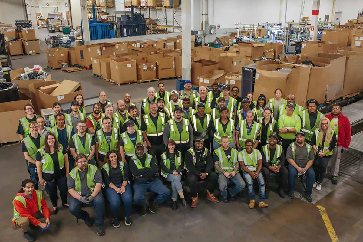 Employees of Repowered in a team photo in the facility.