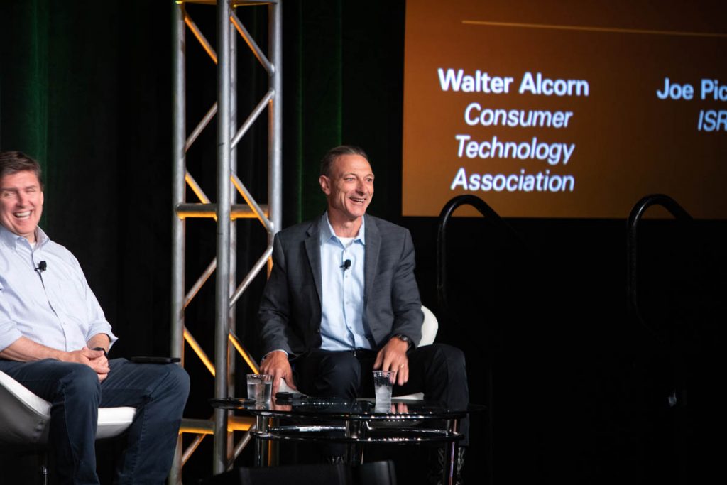 Craig Boswell seated on stage at the 2022 E-Scrap Conference with Walter Alcorn.