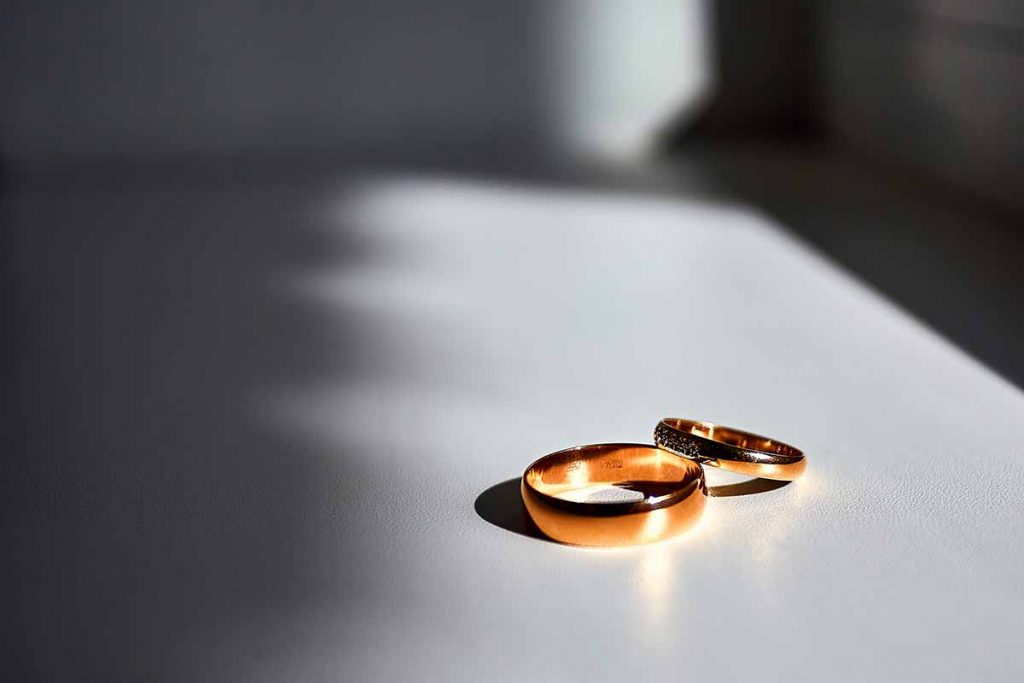 Wedding rings on a white table.