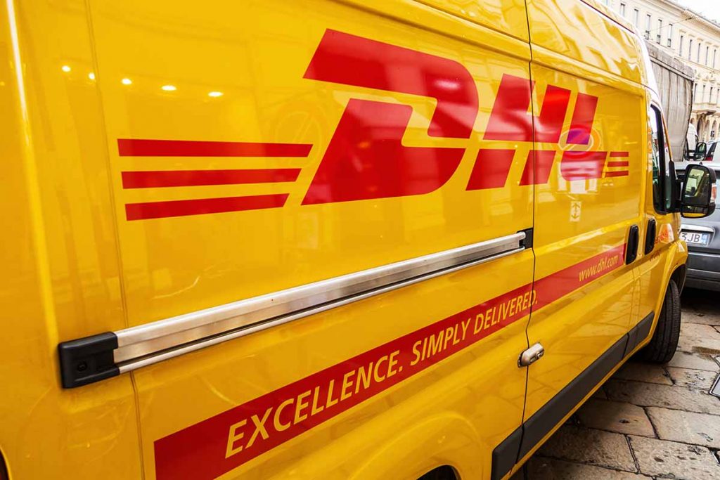 DHL truck parked on a city street.