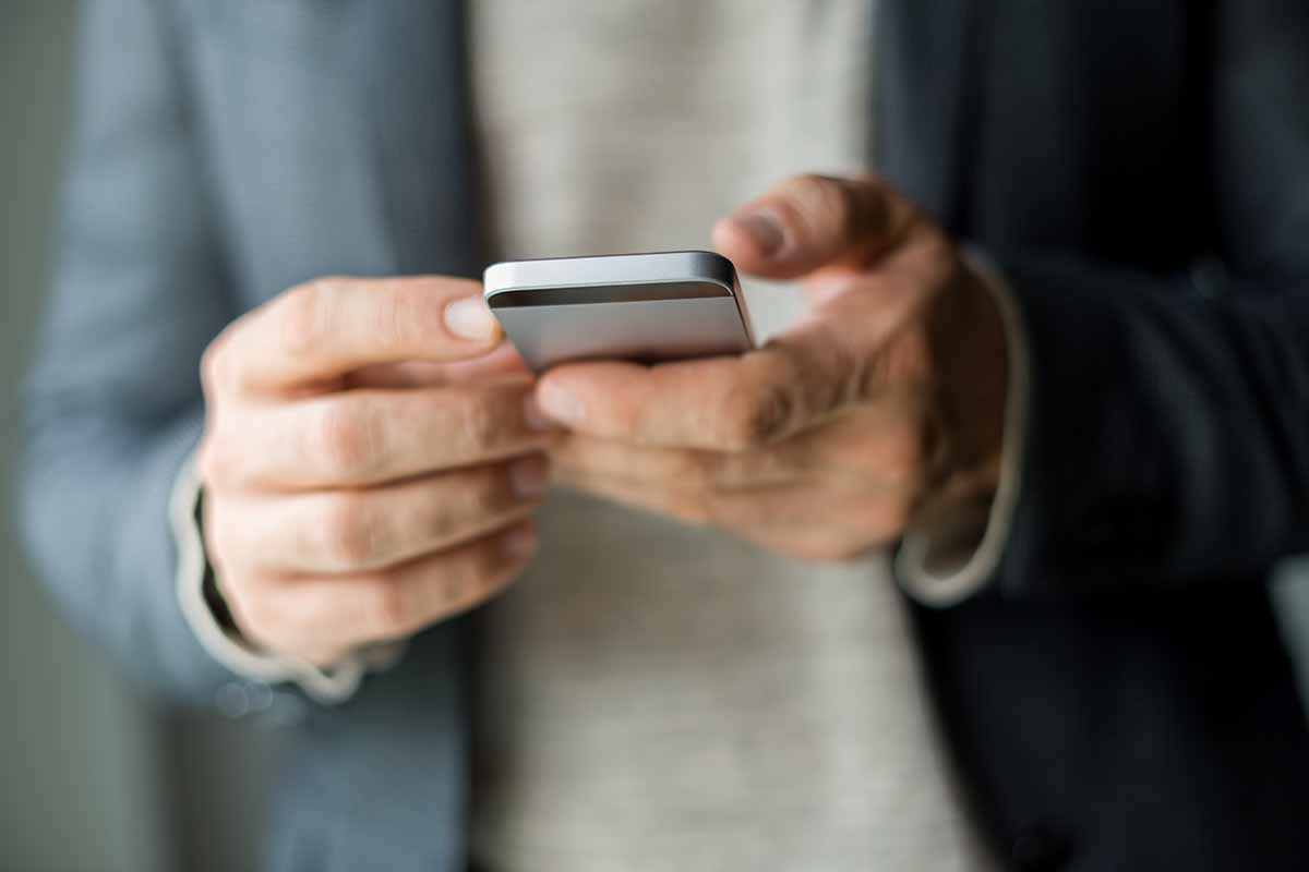 Person with smartphone in their hands.