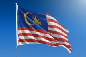 Malaysian flag with blue sky background.