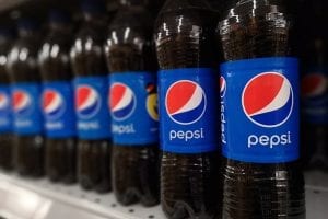 Pepsi bottles on a retail shelf.