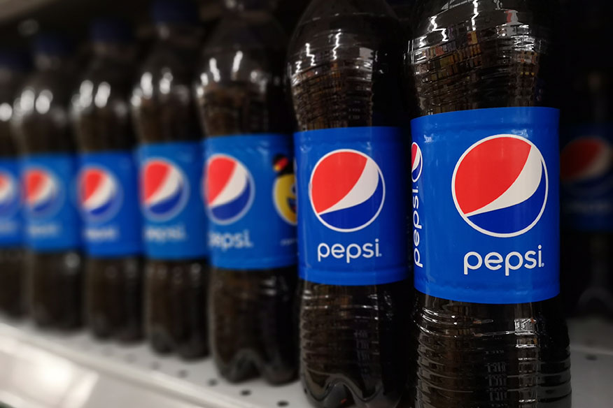 Pepsi bottles on a retail shelf.