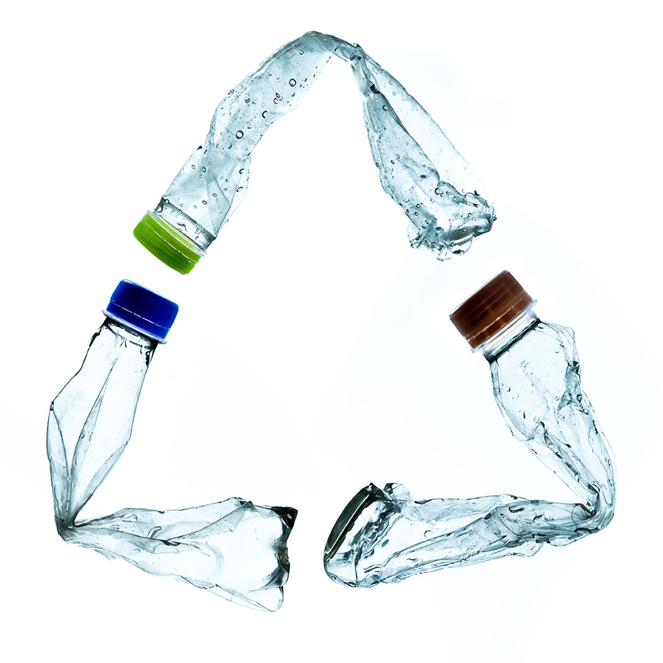 PET bottles arranged in a recycling symbol.