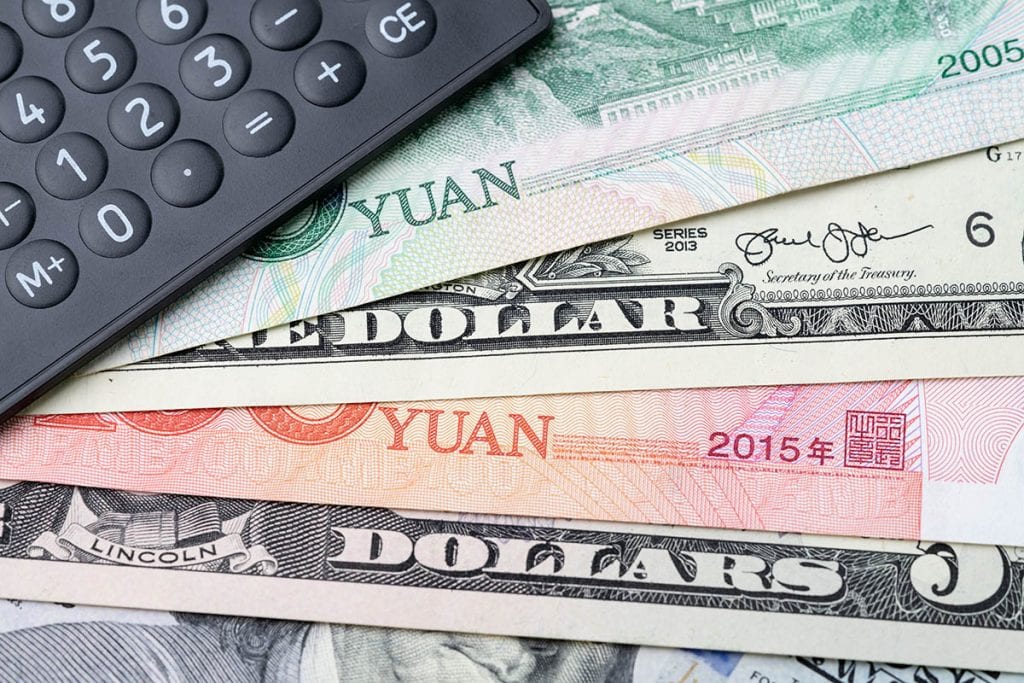 U.S. and Chinese currency with a calculator.