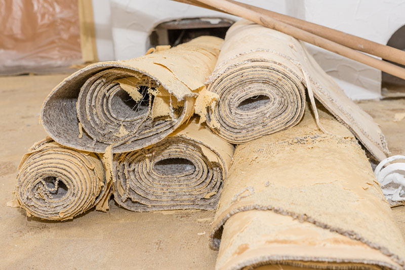 Old carpets rolled up for recycling.