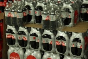 Coca Cola bottles wrapped in plastic at a wholesale market.
