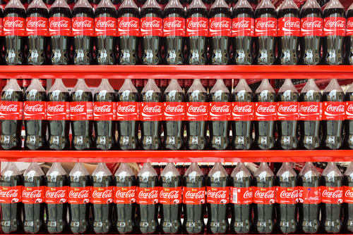 PET bottles of Coca-Cola on a store display.