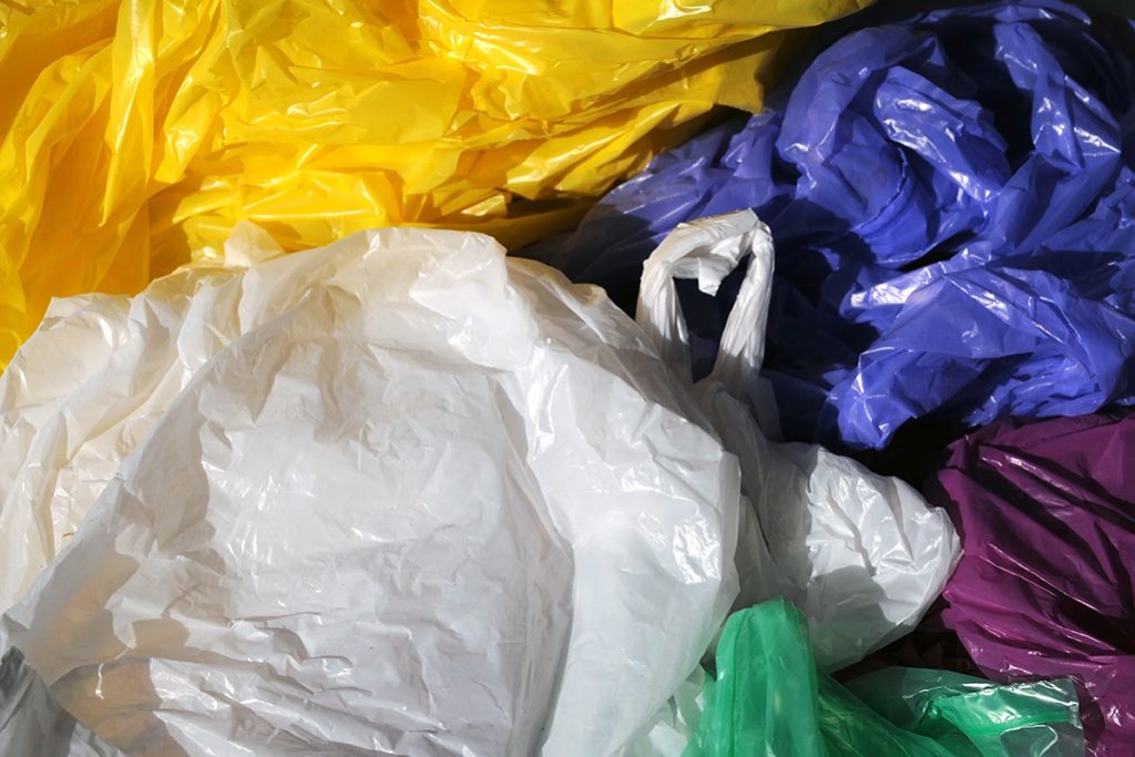 Colorful plastic shopping bags gathered for recycling.