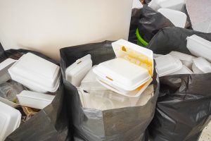 Garbage bags with foam food-service packaging.