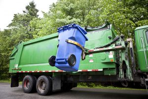 Recycling cart being lifted to hauling truck.