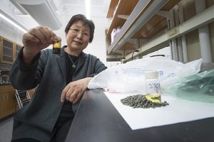 Purdue professor Linda Wang with oil product processed from polyolefins.