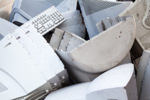 A pile of e-plastics including keyboards and monitor cases.