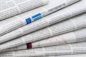 Closeup of stacked newspapers.