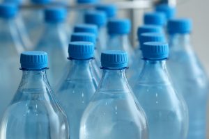 Closeup of plastic water bottles at a bottling plant.