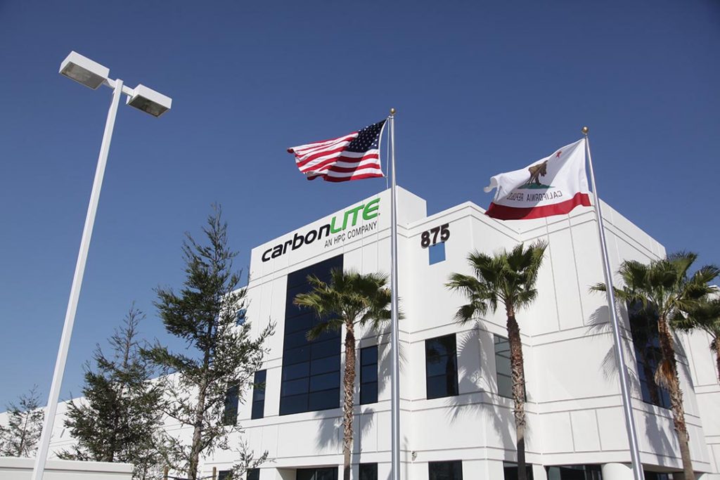 CarbonLite Facility exterior with California and U.S. flags.