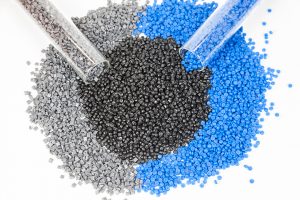 A pile of gray, black and blue plastic pellet.