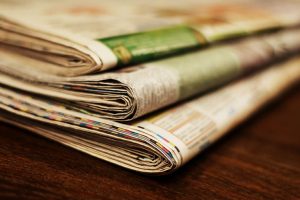 Stack of folded newspapers.