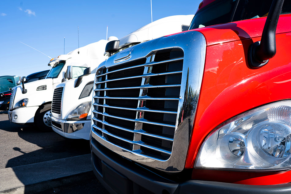 Freight trucks parked in a row.