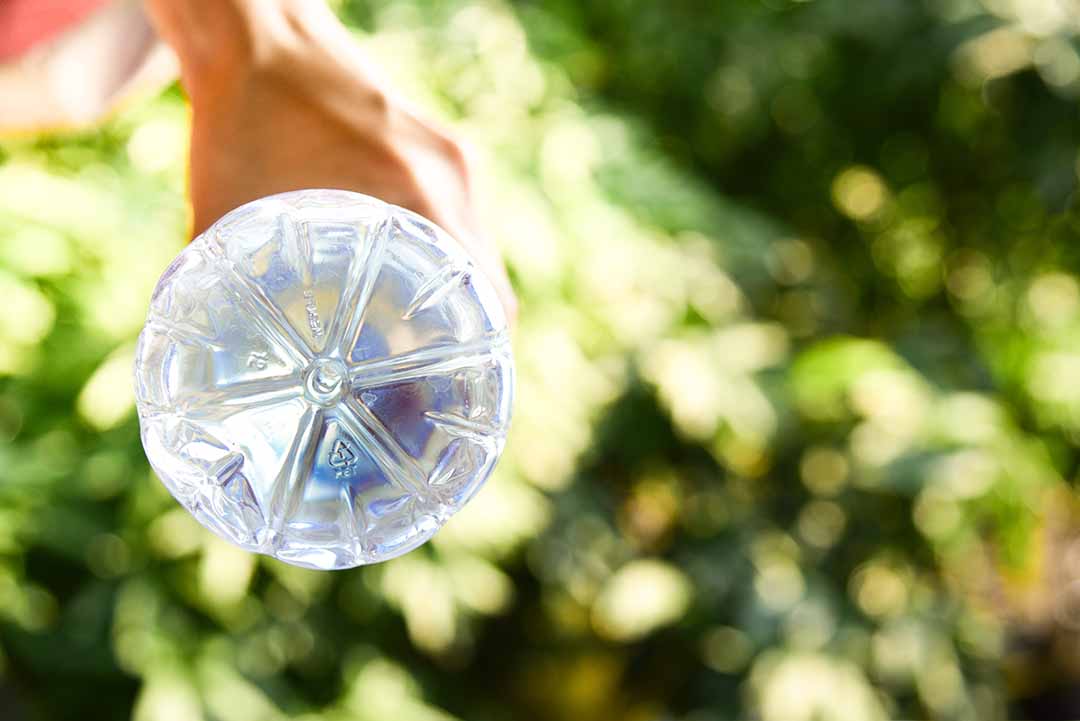 PET plastic bottle in a person's hand.