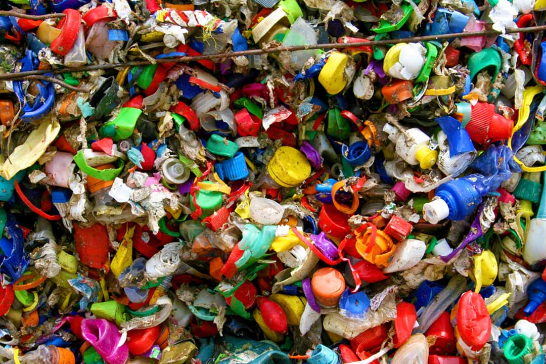 Mixed plastic caps and residuals for recycling.
