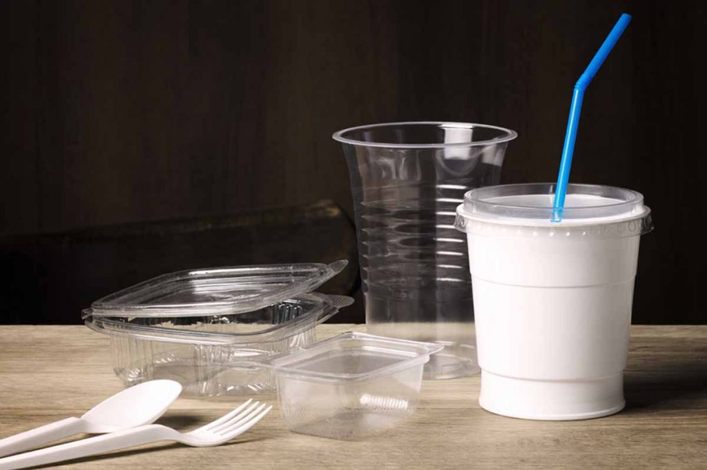Various single-use plastic packaging on a table.