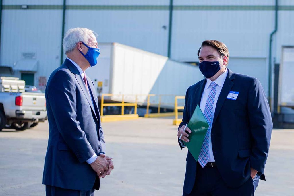 Arkansas Gov. Asa Hutchinson (left) with Sean Whiteley, Revolution's CEO, at an event announcing the film processor's expansion.