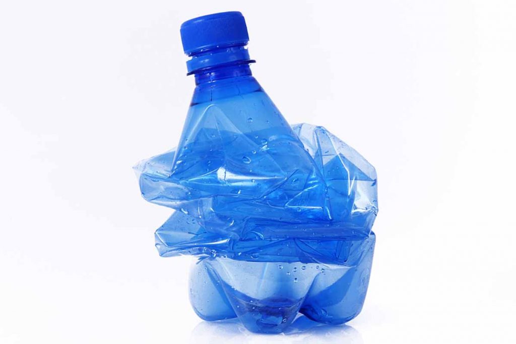 Squashed PET bottle on a white background.