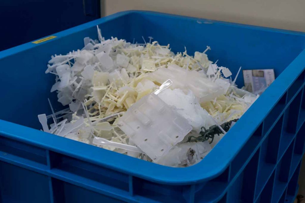Injection molding scrap in a container.