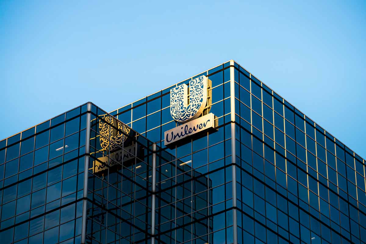 Unilever logo on company building with blue sky above.