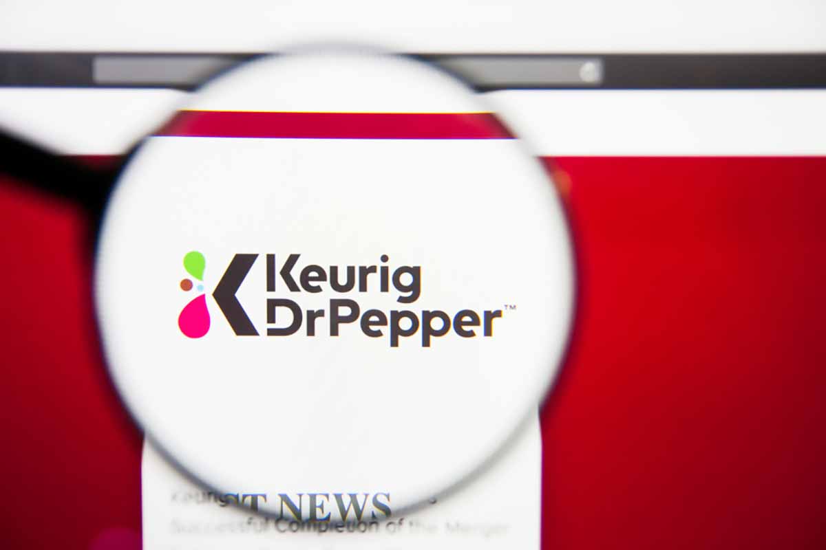 Keurig Dr Pepper logo on screen under magnifying glass