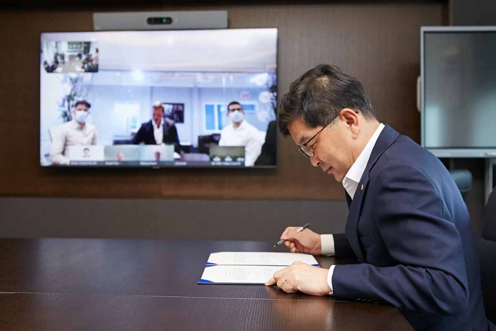 View of SK Global Chemicals and Loop Industries staff signing documents.