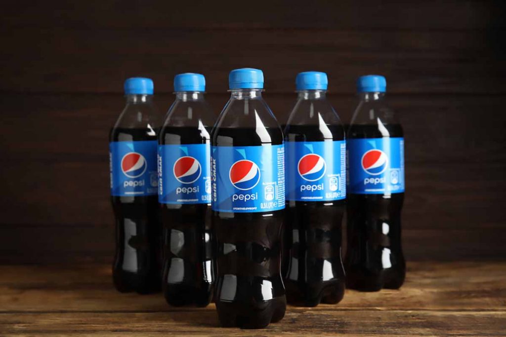 Pepsi bottles arranged on a table.