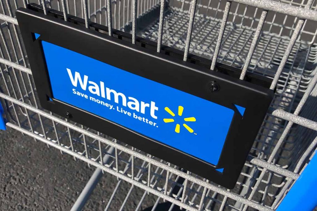Walmart logo on shopping cart in store.